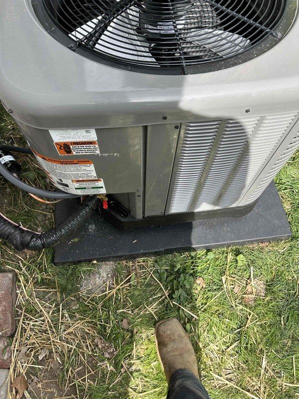 Completed full residential HVAC system installation for first floor heating and cooling. Installed RUUD 14.3 SEER2 two-stage 2-ton heat pump condenser unit (model RP14AY24AJ2NA) on exterior pad with proper leveling and positioning. Mounted RUUD 2-ton air handler (model RH2TY2417STANNJ) in attic space and integrated with existing ductwork system. Installed RUUD 10KW heat kit (model RXBH-1724A10J-B) for supplemental heating capacity. Ran refrigerant line set from attic air handler through exterior wall to outdoor condenser unit with proper insulation and securing. Installed new 14x14 return air grille on second floor stair landing to provide adequate return air flow for first floor system. Fabricated and installed return air ductwork from new grille location to air handler. Modified existing duct system with miscellaneous fittings and adapters to ensure proper integration and airflow distribution. Removed and disposed of existing equipment per standard procedures. Connected refrigerant l