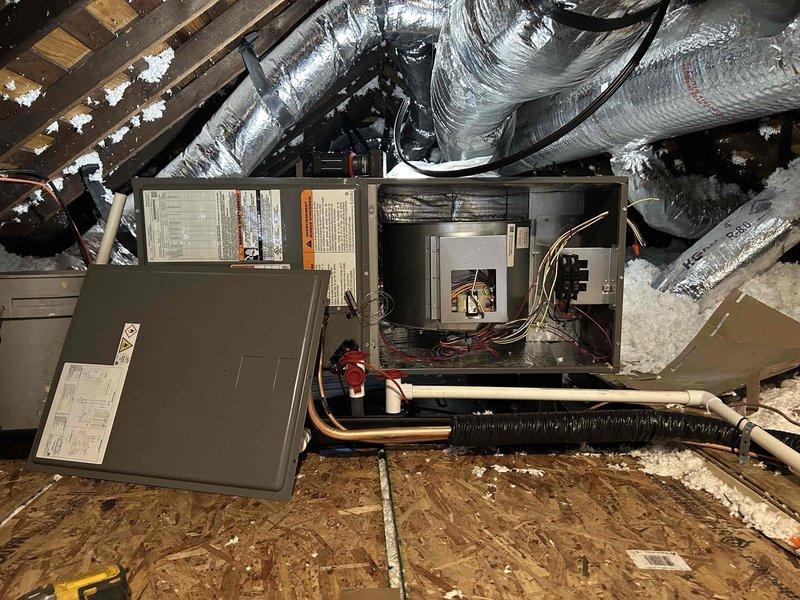Completed full residential HVAC system installation for first floor heating and cooling. Installed RUUD 14.3 SEER2 two-stage 2-ton heat pump condenser unit (model RP14AY24AJ2NA) on exterior pad with proper leveling and positioning. Mounted RUUD 2-ton air handler (model RH2TY2417STANNJ) in attic space and integrated with existing ductwork system. Installed RUUD 10KW heat kit (model RXBH-1724A10J-B) for supplemental heating capacity. Ran refrigerant line set from attic air handler through exterior wall to outdoor condenser unit with proper insulation and securing. Installed new 14x14 return air grille on second floor stair landing to provide adequate return air flow for first floor system. Fabricated and installed return air ductwork from new grille location to air handler. Modified existing duct system with miscellaneous fittings and adapters to ensure proper integration and airflow distribution. Removed and disposed of existing equipment per standard procedures. Connected refrigerant l