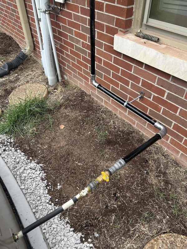 Installed 1" gas piping from main gas line to new generator location. Ran pipe into garage, routed exposed across ceiling, then exited through back of garage. Piping was installed high under the eave and positioned over doors to maintain clearance to generator connection point. Gas line includes proper shut-off valve and complies with code requirements for generator fuel supply.