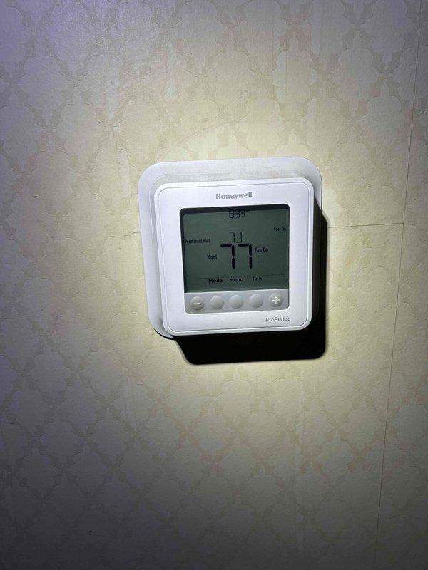 Responded to no cooling complaint on 23-year-old electric air conditioning system with indoor unit located in attic accessed through upstairs closet. Upon arrival, verified thermostat was set to cooling mode and calling for 77 degrees but system was unresponsive. Inspected outdoor condenser unit and found unit would not power on. Diagnosed failed contactor preventing compressor and condenser fan operation. Replaced contactor, restored power to system, and verified proper startup sequence. System now cooling effectively with normal amperage draw on compressor and condenser fan motor operating within manufacturer specifications.