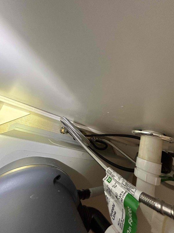 Completed kitchen sink faucet replacement on return visit. Successfully installed modern three-piece faucet system with pull-down spout and dual lever handles in brushed stainless steel finish. Connected all supply lines and verified proper operation with no leaks detected beneath undermount sink installation.
