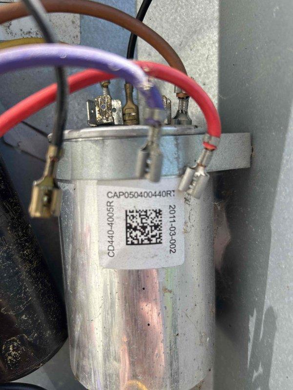 Responded to no cooling complaint on 12-year-old heat pump system. Upon inspection, diagnosed failed dual run capacitor (CAP050400440R1) on outdoor unit. Verified capacitor failure using clamp meter with amperage readings confirming compressor was not operating within normal parameters. Replaced defective capacitor and tested system operation. Unit restored to proper cooling function with compressor and condenser fan motor running at correct amperage. Customer advised that due to system age and presence of multiple units on property, they should anticipate potential replacement needs in the near future.
