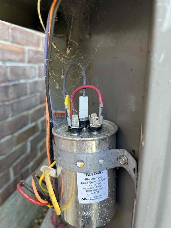 Completed routine AC tune-up on attic-mounted air handler/gas furnace unit located above garage. Inspected and tested dual-run capacitor (TRCFD455, 440/370VAC), verified proper electrical connections and voltage readings at 227VAC, confirmed all compressor and fan motor circuits functioning within normal parameters. Customer provides their own filter for unit maintenance.