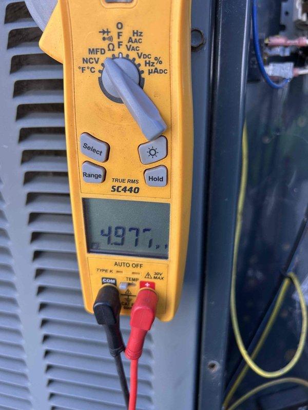Completed biannual preventive maintenance on fifteen-year-old residential air conditioning system. Performed comprehensive tune-up including electrical diagnostics with multimeter reading 497.5 volts, temperature verification across evaporator coil measuring 52.9°F at insulation surface, inspection of furnace and cooling components, and standard safety checks. All equipment operating within normal parameters; system ready for continued service.