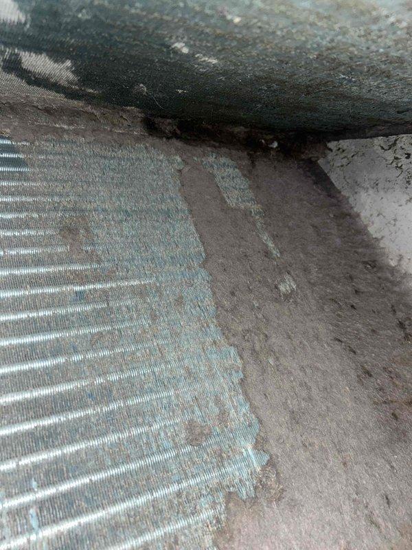 Performed commercial HVAC coil cleaning service on two evaporator coils located in confined crawl space area. Coils exhibited significant dust and debris accumulation on aluminum fins, restricting airflow and reducing system efficiency. Thoroughly cleaned both coil assemblies, removing accumulated particulate matter from fin surfaces and surrounding ductwork to restore proper heat transfer capabilities and optimize unit performance.