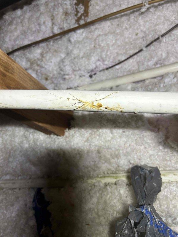 Responded to service call for water leak from AC system into bedroom. Upon arrival, inspected attic space and located clogged condensate drain line causing overflow. Cleared blockage from drain line using appropriate methods and verified proper drainage flow. Inspected surrounding insulation and structural components for water damage. Noted moisture evidence on wooden beam near drain pan area. Confirmed AC system operational with condensate draining properly through cleared line. System tested and no active leaking observed at time of departure.