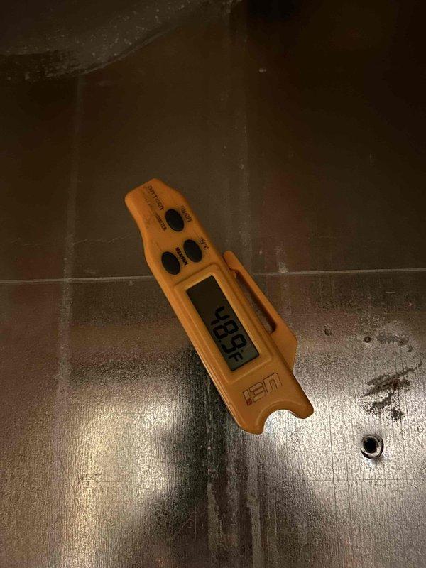 Responded to no cooling complaint on electric HVAC system with indoor unit located in attic. Upon arrival, found unit blowing air but not cooling, condition present since end of previous week. Performed diagnostic evaluation of system components and electrical connections. Inspected capacitor and associated wiring connections at contactor assembly. Used digital multimeter to test electrical components and verify proper voltage and continuity. Identified failed capacitor as root cause of cooling failure. Replaced defective dual run capacitor with proper rated replacement. Verified all wire connections secure at terminals. Tested system operation and confirmed compressor engagement and proper cooling cycle restored. Unit operating within normal parameters at time of departure.