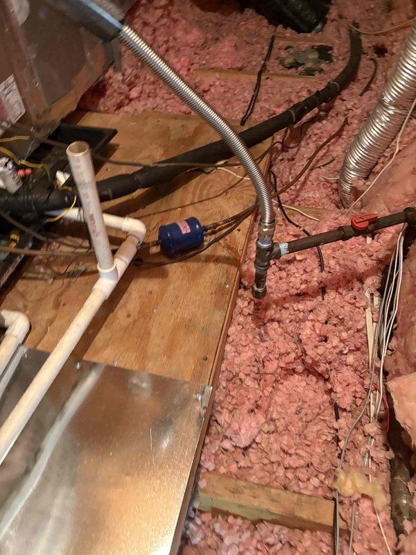Completed installation of Carrier Comfort Series 80% AFUE 90,000 BTU gas furnace model 58SB0B090M21-16 in attic space. Installed two Honeywell TH2110WF4008/U WiFi smart thermostats for multi-zone control. Work included transition connection to existing evaporator coil, standard-sized air filter rack installation, connection to flue piping system, electrical disconnect switch, gas shut-off valve, flexible gas line connector, and flame roll-out safety protection. All ductwork connections secured to furnace plenum with proper sealing. Verified proper combustion air supply and venting configuration per manufacturer specifications. Installed PVC condensate drain line with trap and routed to approved drainage location. Completed all electrical wiring to code including 120V power supply and thermostat low-voltage wiring. Tested gas pressure at manifold and adjusted for optimal burner performance. Conducted system startup procedures including ignition sequence verification, blower motor operat