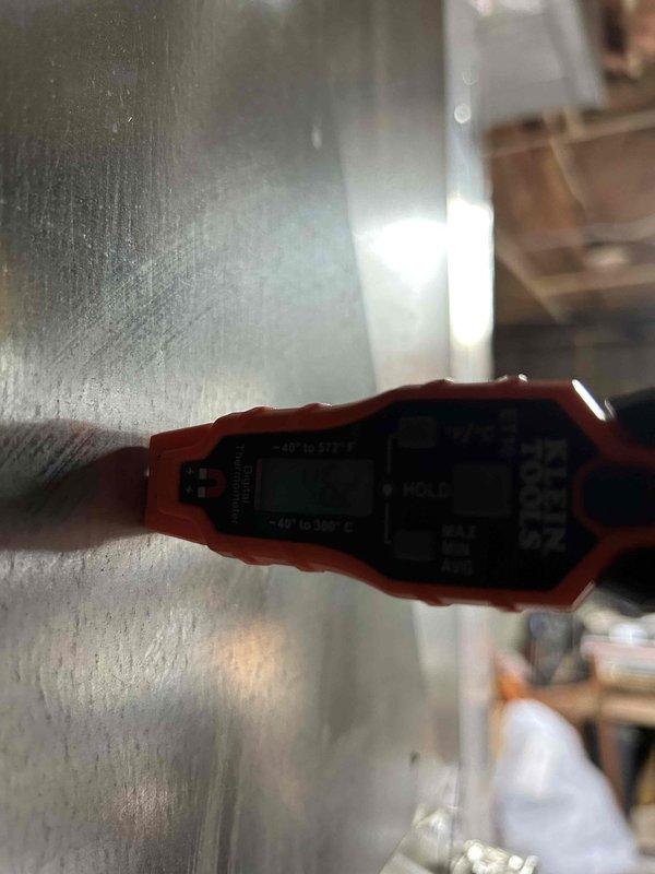 Completed spring AC tune-up on residential cooling system with heat pump located in basement. Performed temperature diagnostics on ductwork using digital measurement tools and inspected evaporator coil assembly and condensate drain pan, noting mineral deposits and staining consistent with normal operation. All maintenance tasks completed per manufacturer specifications with system operating within normal parameters.
