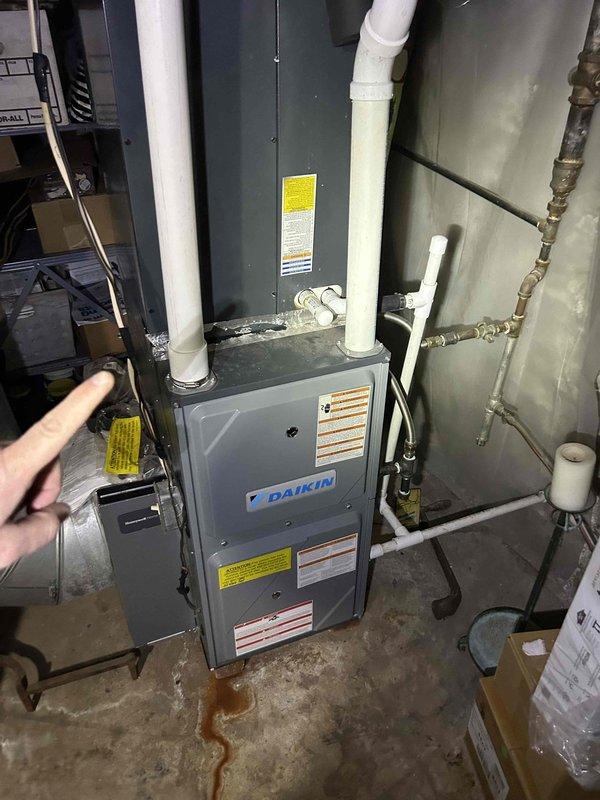 Completed comprehensive Care Plan tune-up on dual-zone HVAC system consisting of two gas furnaces and two air conditioning units located in basement and attic. Performed thorough inspection and testing of Daikin furnace in basement, including visual assessment of unit condition, venting system integrity, and ductwork connections. Conducted electrical diagnostics on outdoor AC condenser unit, measuring capacitor voltage which registered 26.6 volts, indicating proper operation within manufacturer specifications. Verified all safety labels present and legible, confirmed PVC intake and exhaust venting properly installed, and checked for proper drainage with no active leaks observed. Customer provided their own filters for both systems as part of maintenance agreement.