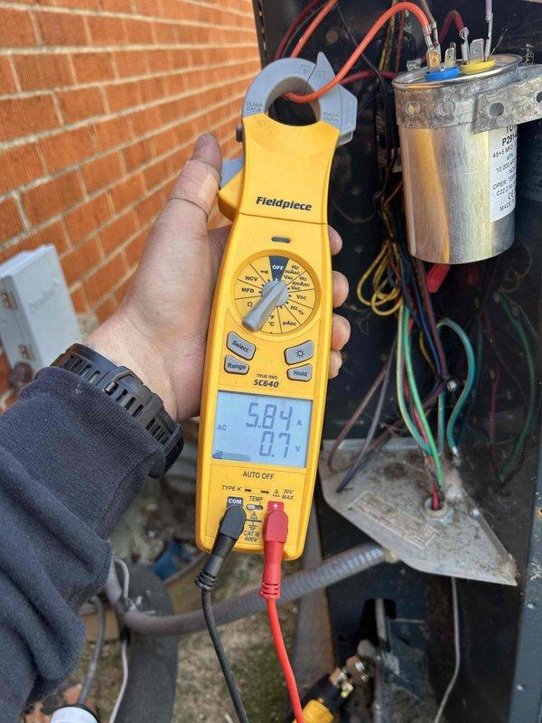 Completed annual air conditioning maintenance as part of club membership plan. Performed electrical diagnostics on outdoor condensing unit, measuring voltage at 241.7V and amperage readings of 5.884A with Fieldpiece clamp meter. Tested capacitor functionality and verified all electrical connections were secure. Changed customer-provided filter as requested. All system components operating within normal parameters upon completion of tune-up service.