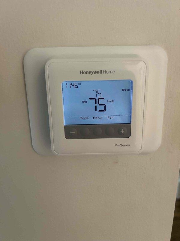 Completed comprehensive heating and air conditioning maintenance inspection on a 2-year-old HVAC system located in basement. Performed standard tune-up procedures on the air handler unit, verified thermostat operation showing proper heating mode functionality at 75°F, and inspected all mechanical components including PVC condensate lines, copper refrigerant lines, and gas connections. System found to be operating within normal parameters with no issues identified; customer providing their own 20x25x4 filters for the unit installed in July 2024.
