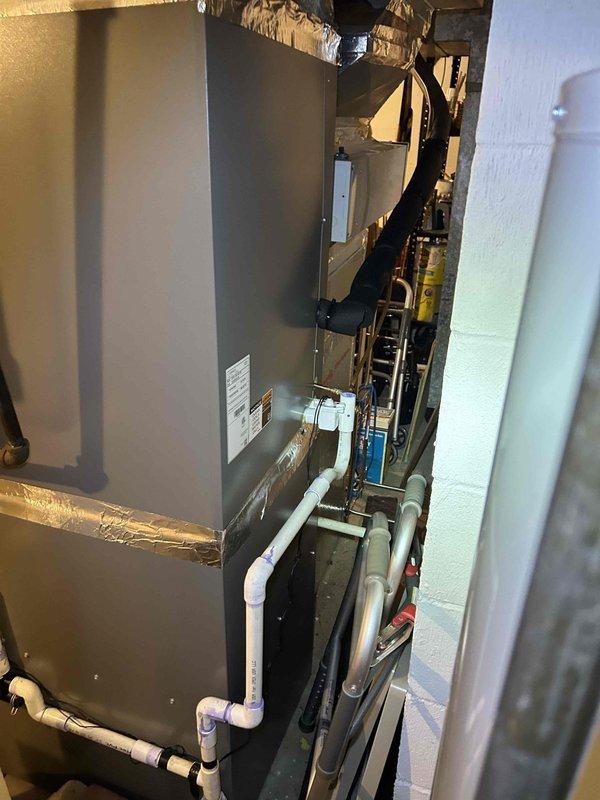 Completed comprehensive heating and air conditioning maintenance inspection on a 2-year-old HVAC system located in basement. Performed standard tune-up procedures on the air handler unit, verified thermostat operation showing proper heating mode functionality at 75°F, and inspected all mechanical components including PVC condensate lines, copper refrigerant lines, and gas connections. System found to be operating within normal parameters with no issues identified; customer providing their own 20x25x4 filters for the unit installed in July 2024.