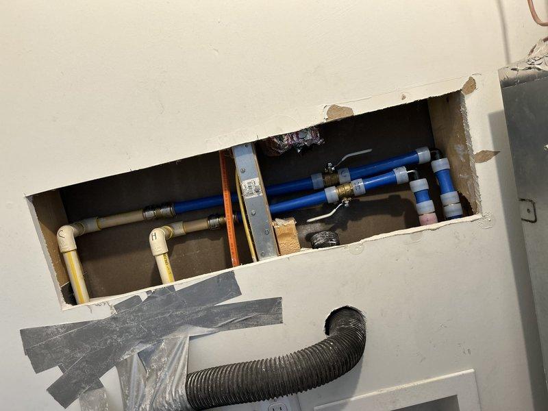 Responded to a water leak in a closet where a PVC hot water supply line was dripping. Accessed the plumbing through an existing access panel and opened the wall cavity to expose the affected area. Identified the leak source in the hot water supply line and repaired the connection using appropriate fittings. Installed blue-handled ball valves on multiple supply lines for improved shutoff capability. Replaced damaged PVC sections with PEX tubing in the configuration, securing all connections with proper fittings and connectors. Tested all repaired connections for leaks and verified proper water flow throughout the system.