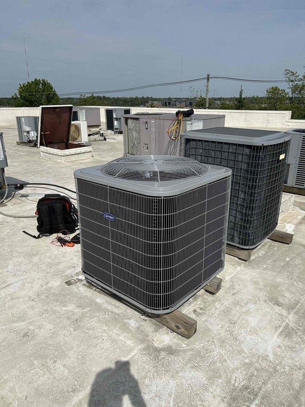 Completed commercial heat pump system installation for conference room climate control. Installed Carrier 5-ton 3-phase heat pump unit (model 27SCA560A005) on rooftop using crane lift, paired with Carrier 5-ton air handler (model FJ5ANXD60L00) mounted in women's bathroom ceiling. Integrated 15KW heat kit (model KFCEH1601315) for supplemental heating capacity and connected system to existing thermostat. Obtained all applicable permits, removed and disposed of existing equipment, and completed installation per code compliance standards.