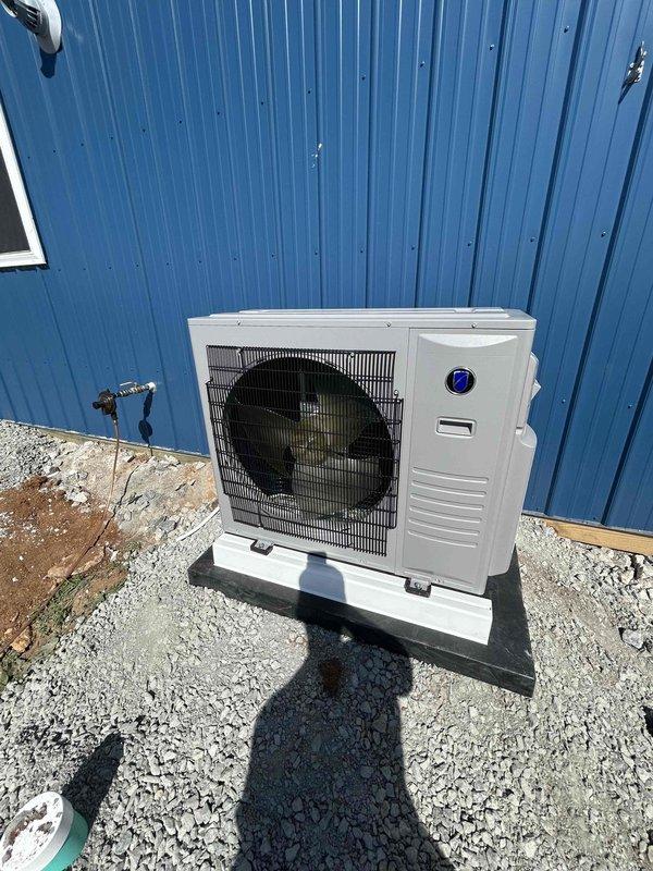 Successfully installed a Friedrich 24K BTU low-temperature mini split system consisting of a ProX Series outdoor condenser unit (FPHFR24A3D) and indoor wall mount air handler (FAHFW24A3D) with refrigerant line set. The outdoor unit was mounted on a composite pad with isolation base in a confined service area between buildings, complete with electrical disconnect box, whip kit, snow legs, and insulated refrigerant lines routed through the building wall, with main electrical connection to be completed by others per scope.