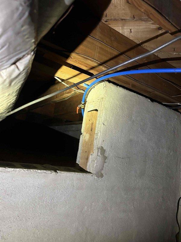 Replaced copper water line in attic space in preparation for new refrigerator installation. Routed new supply line through existing structural framework, securing properly to wooden joists and coordinating with existing utility runs including electrical wiring and HVAC components. Completed installation meets code requirements for refrigerator water connection.