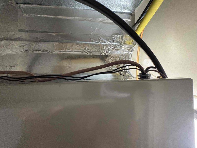 Completed full residential HVAC system installation featuring a Carrier 2-ton 16 SEER2 single stage heat pump (model 27SCA524A003), Carrier 2-ton air handler (model FJ5ANXB24L00), and Carrier 10KW heat kit (model AFAEHL10B01A). Installed Honeywell digital thermostat for system control and programmed unit for optimal operation. Mounted outdoor heat pump unit on existing concrete pad with snow legs for proper elevation and drainage. Installed electrical disconnect box and electrical whip kit for safe power connection to outdoor unit. Positioned indoor air handler in attic space and connected to existing ductwork system with proper transitions. Installed refrigerant line set with full insulation between outdoor and indoor units, including refrigerant line filter for system protection. Applied trap and SS2 coil drain safety water sensor to condensate drain system with PVC drainage piping to prevent water damage. Installed standard-sized air filter rack for easy maintenance access. Complete