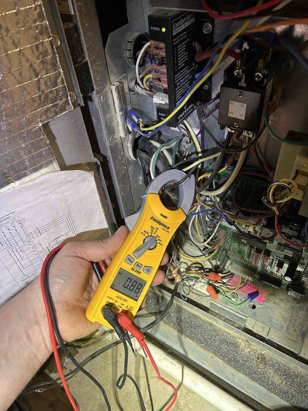 Completed scheduled maintenance tune-up on geothermal heat pump system and basement dehumidifier unit per care plan agreement. Performed comprehensive electrical diagnostics using digital multimeter to verify proper voltage and amperage readings across all system components. Inspected control board, contactors, relays, and wiring connections within equipment cabinet, confirming all electrical components operating within manufacturer specifications. Verified thermostat functionality with Water Furnace control unit displaying proper temperature readings and cooling mode operation at 72-73 degrees. All system components found to be in good working order with no deficiencies noted.
