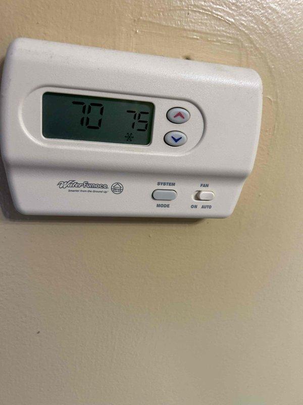 Completed scheduled maintenance tune-up on geothermal heat pump system and basement dehumidifier unit per care plan agreement. Performed comprehensive electrical diagnostics using digital multimeter to verify proper voltage and amperage readings across all system components. Inspected control board, contactors, relays, and wiring connections within equipment cabinet, confirming all electrical components operating within manufacturer specifications. Verified thermostat functionality with Water Furnace control unit displaying proper temperature readings and cooling mode operation at 72-73 degrees. All system components found to be in good working order with no deficiencies noted.