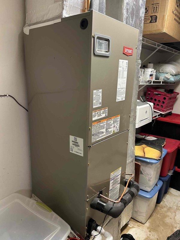 Completed full HVAC system installation in upper right hallway closet location, including Bryant 2-ton 14.3 SEER2 heat pump model GH5SAN52400A, Bryant air handler model FJ5ANXB24L00, and Bryant 8KW heat kit model TU-EC-08BKB. Utilized existing outdoor unit pad with snow legs for proper equipment support and drainage. Installed electrical whip kit and disconnect box for code-compliant power supply to outdoor unit. Ran and insulated refrigerant lines with inline filter between outdoor heat pump and indoor air handler. Configured air handler with proper trap installation and SS2 coil drain safety water sensor for condensate management. Transitioned air handler to existing ductwork system and installed standard-sized air filter rack for maintenance accessibility. Retained existing thermostat for system control. Removed and disposed of old equipment per regulations. Obtained applicable permits and completed installation to code compliance standards. System tested and operational with 10-yea