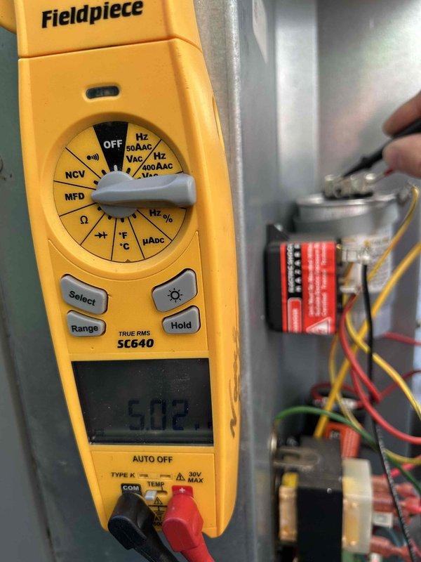 Completed Care Plan tune-up on air conditioning unit with gas furnace located in crawlspace. Performed comprehensive electrical diagnostics including capacitor testing, which measured within acceptable range at 50.02 microfarads on the Titan Pro TRCFD405 dual run capacitor. Inspected all electrical connections, contactors, and wiring integrity throughout the system. Verified proper operation of all components and connections to ensure optimal system performance for the cooling season.