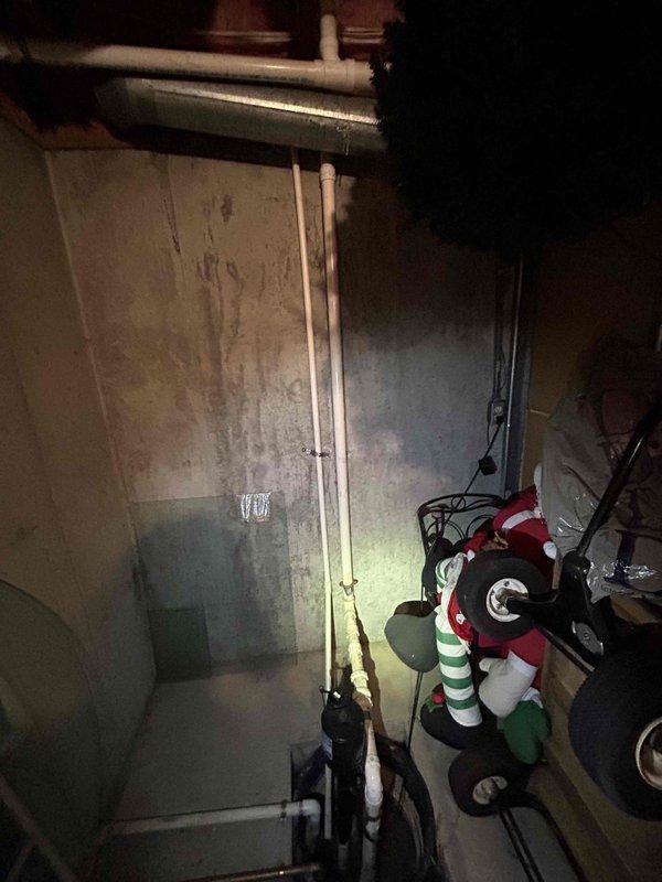 Conducted on-site assessment for sump pump relocation in basement utility area as requested by LFUCG. Evaluated existing conditions including concrete foundation with visible moisture staining, current plumbing infrastructure with PVC drainage lines, exposed floor joists, and HVAC ductwork routing. Documented existing sump pump location and surrounding mechanical systems to prepare comprehensive estimate for relocating unit to optimal position for improved drainage performance and accessibility. Estimate documentation forwarded to homeowner and municipal contact for review and approval.
