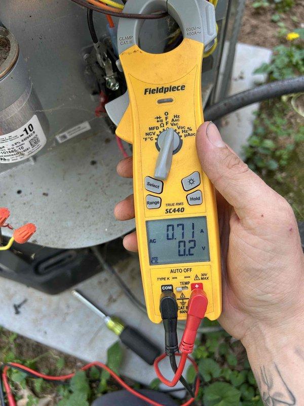 Completed preventive maintenance tune-up on air conditioning system per care plan agreement. Performed comprehensive system inspection including electrical diagnostics with clamp meter, recording amperage draw of 7.1A and voltage reading of 22V at condenser unit. Inspected dual-run capacitor rated at 40+5µF 440VAC, verified proper electrical connections, and confirmed all components operating within manufacturer specifications.