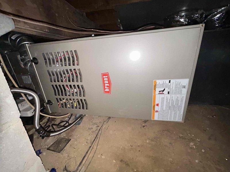 Responded to no-heat call on 2-month-old Bryant furnace installation. Upon arrival, found unit unresponsive with no power to control board. Inspected electrical connections and discovered loose wire at transformer terminal, likely caused by inadequate tightening during initial installation. Secured all electrical connections, verified proper voltage at transformer and control board, and tested system operation through multiple heating cycles. Unit now operating normally with proper ignition sequence and no fault codes present.