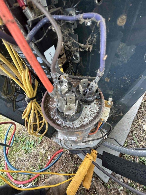 Responded to no cooling complaint with indoor temperature reading 3 degrees above setpoint. Upon inspection of outdoor condensing unit, found heavily corroded compressor motor with significant deterioration of internal components, extensive debris accumulation restricting airflow, and aged electrical connections showing weathering. Unit exhibited advanced oxidation throughout, compromised wiring insulation, and organic matter buildup on refrigerant lines and internal surfaces. Due to severe component degradation and age-related failure of compressor assembly, recommended complete system replacement as repair would not be economically feasible given the extent of corrosion and mechanical deterioration present.