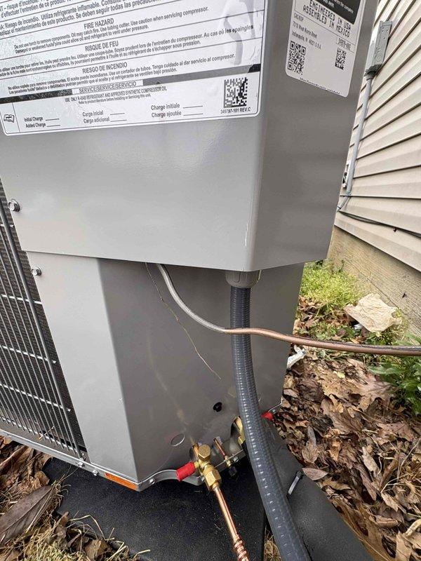 Completed full residential HVAC system replacement including installation of Bryant 2-ton 14.3 SEER2 heat pump (model GH5SAN52400A) with matching air handler (model FJ5ANXB24L10) and 10kW electric heat kit (model TU-EC-10BKB). Removed and properly disposed of existing equipment per code requirements. Installed outdoor unit on new equipment pad with snow legs for elevation and proper drainage. Ran insulated refrigerant lines with inline filter from outdoor heat pump to indoor air handler, securing copper tubing with proper supports and protection. Installed electrical whip kit and disconnect box at outdoor unit for code-compliant power supply. Mounted air handler in interior location with overflow drain pan equipped with water sensor for secondary protection against potential leaks. Added SS2 coil drain safety water sensor and trap to primary condensate line for proper drainage and system protection. Fabricated transitions to connect new air handler to existing ductwork, ensuring proper