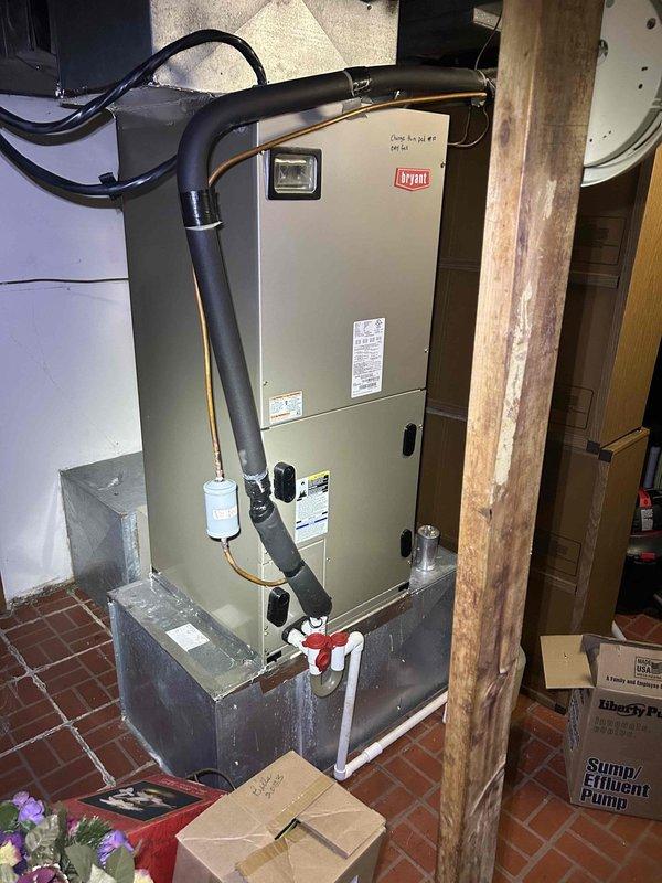 Completed prepaid Gold Level maintenance on a 7-year-old Bryant heat pump and air handler system located in basement. Performed comprehensive inspection of both indoor and outdoor units, including electrical testing which confirmed proper voltage readings at 9.59 volts on control circuit. Examined all electrical connections, terminal blocks, and capacitor at outdoor unit. Inspected indoor air handler installation, verified proper operation of condensate drainage system with PVC piping and red-handled shutoff valves. Checked all refrigerant line insulation and ductwork connections. System required 20x25x5 filter media. All components found operating within normal parameters with no immediate repairs needed. Documented equipment condition with photos showing both indoor basement installation and outdoor unit electrical panel inspection. Unit performing efficiently with no safety concerns identified during this routine maintenance visit.