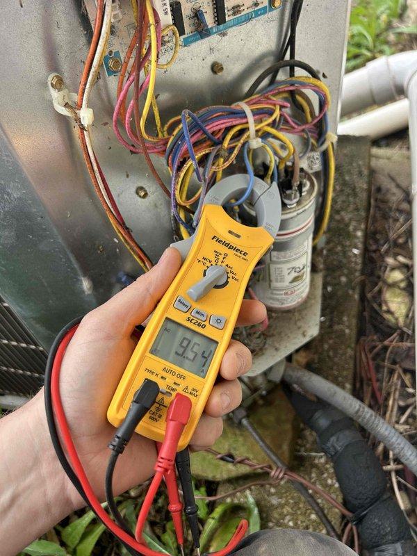 Completed prepaid Gold Level maintenance on a 7-year-old Bryant heat pump and air handler system located in basement. Performed comprehensive inspection of both indoor and outdoor units, including electrical testing which confirmed proper voltage readings at 9.59 volts on control circuit. Examined all electrical connections, terminal blocks, and capacitor at outdoor unit. Inspected indoor air handler installation, verified proper operation of condensate drainage system with PVC piping and red-handled shutoff valves. Checked all refrigerant line insulation and ductwork connections. System required 20x25x5 filter media. All components found operating within normal parameters with no immediate repairs needed. Documented equipment condition with photos showing both indoor basement installation and outdoor unit electrical panel inspection. Unit performing efficiently with no safety concerns identified during this routine maintenance visit.