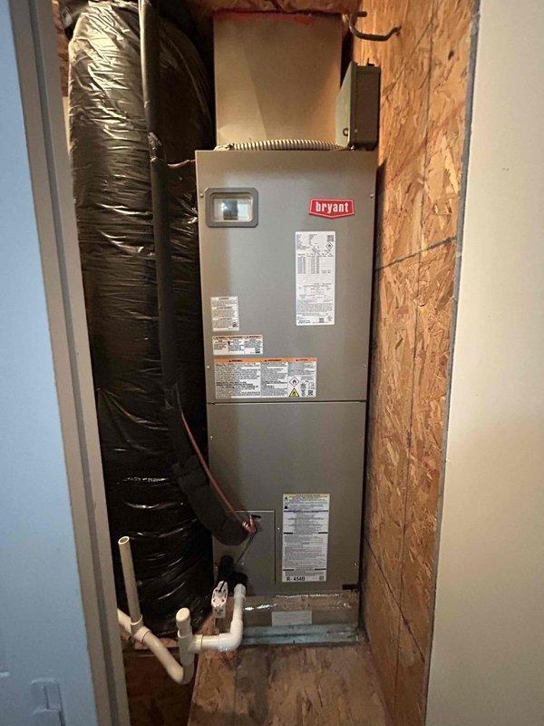 Completed full residential heat pump system installation including Bryant 2-ton 15 SEER2 heat pump unit (model GH5SAN52400A), Bryant 2-ton air handler (model FJ5ANXB24L00), and Bryant 10KW heat kit (model TU-EC-10BKB). Removed and disposed of existing HVAC equipment, installed new air handler in interior utility closet with proper mounting and leveling, connected black flexible ductwork with reflective insulation, and installed white PVC condensate drain lines with appropriate fittings and elbow joints. Positioned outdoor heat pump unit on existing concrete pad, installed snow legs for elevation, and connected electrical whip with disconnect box for code compliance. Applied refrigerant line insulation to copper linesets, installed refrigerant line filter, charged system to manufacturer specifications, and performed startup procedures. Integrated existing thermostat with new equipment, verified all electrical connections meet code requirements, tested heating and cooling cycles for prop