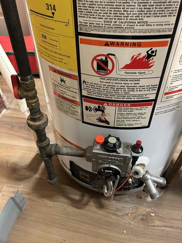 Performed routine maintenance flush on tanked water heater to remove sediment buildup and maintain optimal efficiency. Drained water heater completely through bottom drain valve, cleared accumulated mineral deposits and debris from tank bottom, then refilled unit and verified proper operation of all safety components including temperature/pressure relief valve and gas control system.
