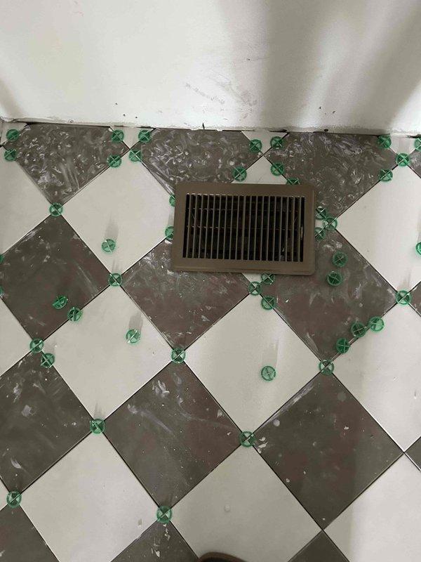 Completed final warranty inspection and preparation for building inspection on new HVAC installation. Replaced 16x20x1 air filter and taped filter access panel in preparation for required duct blast testing. Repaired damaged living room return panning where subfloor had been compromised, including metal pan repair, mastic resealing, and foil-backed insulation restoration. Installed all supply and return registers and grilles throughout upper and lower levels of residence. Secured thermostat mounting to wall and performed comprehensive system inspection to verify installation readiness for final building code inspection.