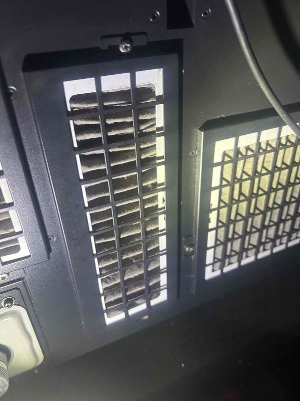 Responded to no cooling complaint on commercial HVAC system with reported inadequate exhaust airflow. Upon inspection, found exhaust motor shaft exhibiting severe rust and corrosion causing binding and reduced rotation speed. Verified ventilation grilles were properly secured but airflow was significantly restricted due to failed motor bearing assembly. Documented equipment condition with photos showing corroded shaft and ventilation components. Recommended immediate motor replacement to restore proper exhaust function and prevent complete system failure.