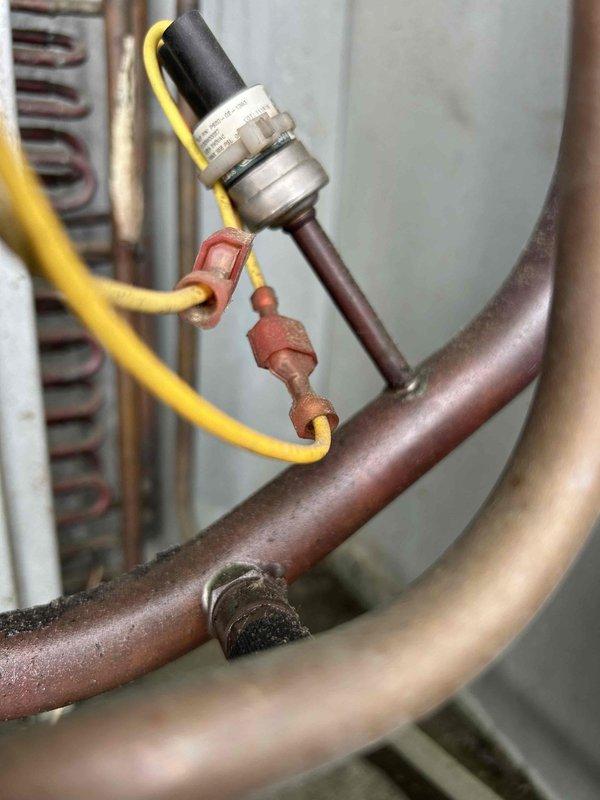 Responded to no cooling complaint on commercial property with multiple roof-mounted electric HVAC units. Performed diagnostic evaluation on underperforming equipment, accessing roof-mounted condensers and evaporator components. Inspected refrigerant lines, pressure sensors, and electrical connections on affected units, documenting system conditions with detailed photography of copper piping assemblies, pressure transducers, and control wiring for further assessment and repair recommendations.
