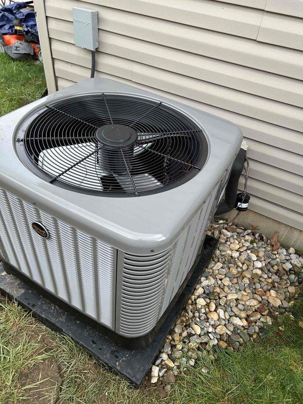 Completed full residential HVAC system installation featuring RUUD 2.5 ton 14.3 SEER2 heat pump (model RP14AY30AJ2NA), RUUD air handler (model RH2TY3617STANNJ), and RUUD 10 KW heat kit (model RXBH-1724A10J-B). Installed outdoor condenser unit on new pad with snow legs, electrical disconnect box, and whip kit; refrigerant lines insulated and equipped with line filter. Indoor installation included air handler with 10 KW auxiliary heat strip, overflow drain pan with water sensor, SS2 coil drain safety sensor, trap, and transition to existing ductwork. Upgraded return grille from 20x20 to 20x25 for improved airflow and installed standard-sized filter rack with Honeywell digital thermostat for system control. All refrigerant lines properly insulated, system charged, and tested; verified pressures and vacuum levels using manifold gauges. Removed and disposed of existing equipment, obtained necessary permits, and ensured all work met code compliance standards. System commissioned and operatio