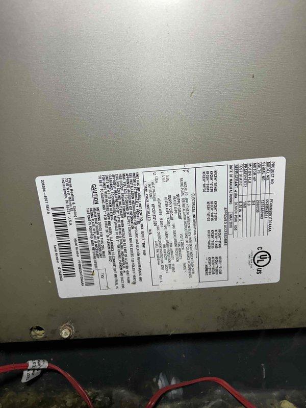 Responded to no cool call on residential air conditioning system with air handler located in attic. Upon inspection, found evaporator coil heavily loaded with dust and debris accumulation, significantly restricting airflow and reducing cooling capacity. Documented system condition with photographs of specification label and internal components showing substantial particulate buildup on heat exchanger fins. Advised customer that dirty coil is primary cause of reduced cooling performance and recommended professional coil cleaning service to restore proper system operation and efficiency.