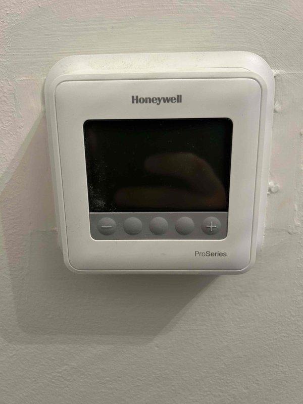 Responded to no-cooling call on eight-year-old residential air conditioning system. Upon arrival, found Honeywell ProSeries thermostat display powered off and system unresponsive to commands. Inspected HVAC equipment in basement mechanical room, including air handler unit and associated components. Diagnosed thermostat power failure as root cause of system shutdown. Restored power to thermostat, verified proper display function, and confirmed system response to cooling commands. Tested air handler operation and verified normal startup sequence. System returned to full operational status with all components functioning as designed.