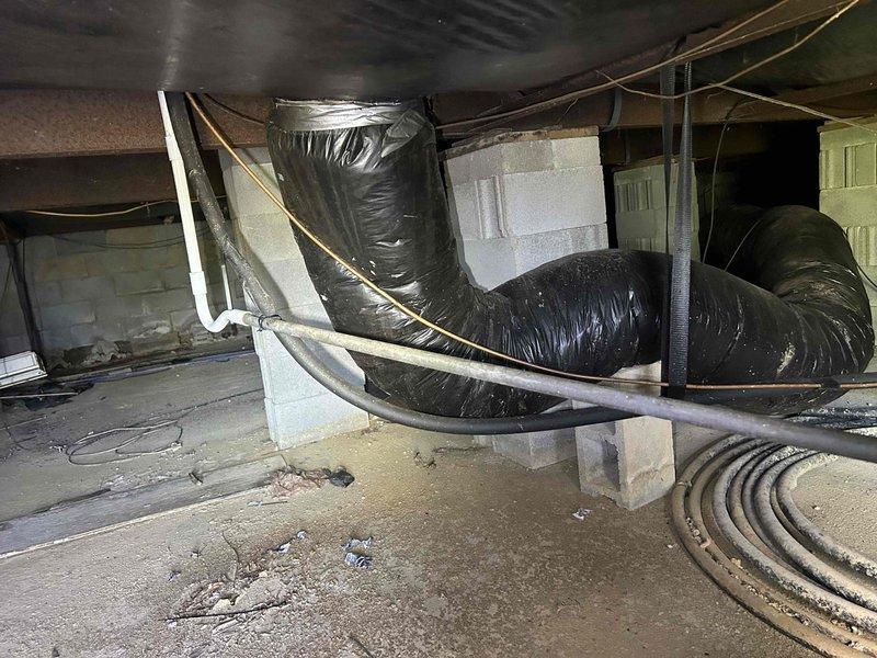 Completed scheduled maintenance on 10-year-old heat pump and air handler system located in interior closet. Performed comprehensive inspection of all accessible components including blower assembly, ductwork, and crawl space installation. 

Blower wheel showed heavy accumulation of dust and debris throughout fin assembly, indicating extended operation without prior cleaning. Thoroughly cleaned blower wheel and housing to restore proper airflow and system efficiency. Inspected flexible ductwork in crawl space, noting black vinyl-wrapped supply ducts properly supported by fabric straps from floor joists. Verified all ductwork connections secure with no visible air leaks. Checked electrical connections and confirmed proper system operation. Customer providing their own filters per maintenance agreement. System operating within normal parameters upon completion of service.