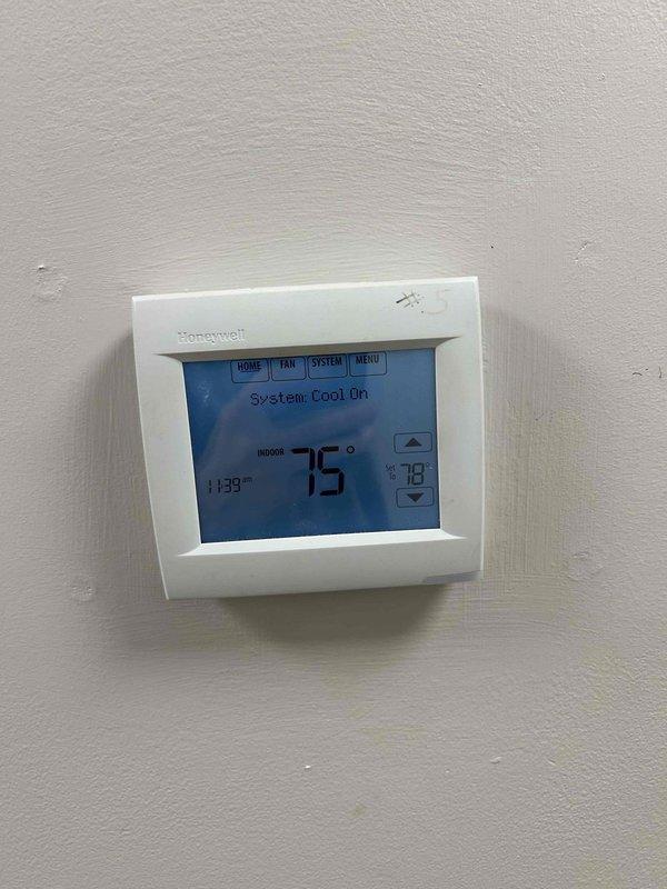 Responded to no cooling complaint on 2-year-old electric HVAC system located on first floor clinic. Upon arrival, found thermostat calling for cooling with system set to 73°F but space temperature at 75°F. Performed diagnostic evaluation of indoor unit and verified proper power supply to equipment. Inspected Honeywell Equipment Interface Module and confirmed all low-voltage wiring connections were secure with no visible damage to control circuits. System successfully restored to normal cooling operation.