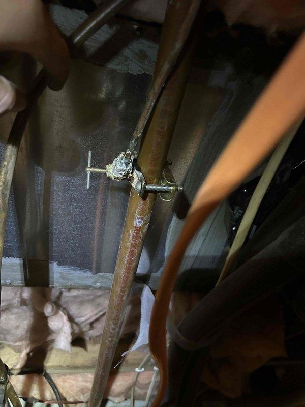 Responded to emergency call for leaking waterline in crawl space that had previously been repaired but was damaged during recent generator installation by another contractor. Upon inspection, located the compromised copper waterline running through the crawl space joists. The line showed evidence of physical impact and active leakage at the damaged section. Shut off water supply to the affected line, cut out the damaged portion of copper pipe, and installed new copper pipe section with proper fittings and soldered joints. Applied pipe clamps for additional reinforcement at the repair points. Tested the repaired waterline under full pressure to verify complete seal with no leaks detected. Cleaned work area and removed all debris from crawl space. System restored to full operational status.