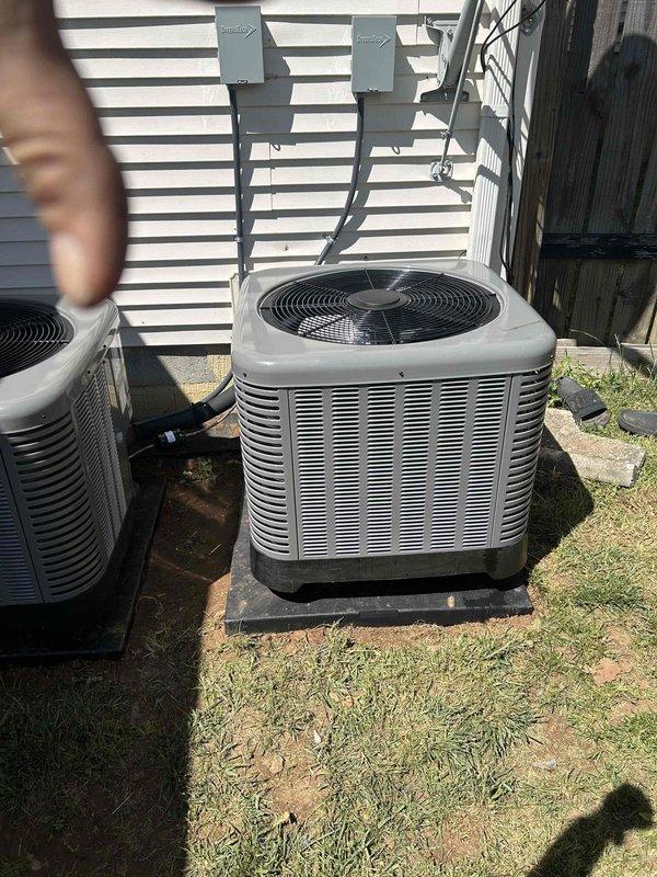 Completed full residential HVAC system installation for first floor consisting of RUUD 2-ton 14.3 SEER2 two-stage heat pump (model RP14AY24AJ2NA), RUUD 2-ton air handler (model RH2TY2417STANNJ), and RUUD 10KW heat kit (model RXBH-1724A10J-B) with digital thermostat. Outdoor heat pump unit installed on concrete pad in backyard with electrical disconnect box mounted on exterior wall, electrical whip kit, refrigerant line insulation, refrigerant line filter, and snow legs for elevated installation. Indoor air handler installation included transition to existing ductwork, standard-sized air filter rack, trap, SS2 coil drain safety water sensor, and ceiling saver overflow drain pan with water sensor for secondary drain protection. Removed and properly disposed of existing equipment per code requirements. Obtained all applicable permits and completed electrical connections including conduit runs from disconnect boxes to outdoor units. System tested and verified operational with proper refrig