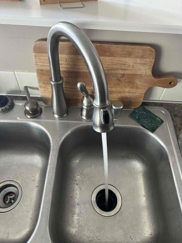 Responded to customer complaint of foul-smelling water requiring diagnostic testing. Inspected residential water heater system and plumbing connections, including flexible supply lines, PVC piping, and brass fittings. Tested water quality at kitchen sink fixture to identify source of odor issue. Examined water heater condition, noting installation date and current operational status. Evaluated both hot and cold water supply to determine if odor was isolated to water heater or present throughout plumbing system. Recommended appropriate treatment solution based on diagnostic findings to resolve water quality concern.