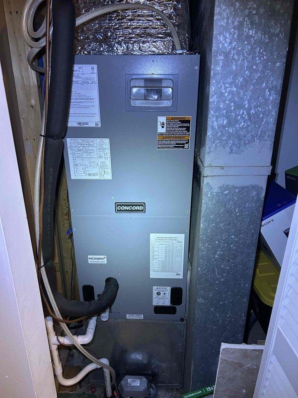 # HVAC Service Call - No Cooling with System Freeze-Up

Responded to a no cooling complaint on a 5-year-old electric Concord air handler system located in the garage. Customer reported the unit had been freezing up for two days and would only blow air after shutting down to thaw. Upon arrival, the system was already thawed out.

Performed visual inspection of the Concord air handler unit and surrounding installation. Examined the indoor air handler cabinet, ductwork connections, condensate drainage system, and accessible refrigerant lines. Inspected flexible ductwork at the supply plenum and verified proper connection to the distribution system. Checked PVC condensate drain lines and tubing for proper pitch and drainage.

Documented equipment condition through photographs showing the air handler installation, manufacturer labels, specification plates, and wiring diagrams affixed to the unit cabinet. Noted the system appeared clean and well-maintained with no obvious signs of physical d
