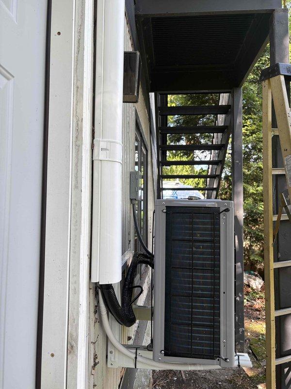 Completed installation of line hide system for new mini split unit at residential property. Concealed refrigerant line set, control wiring, and condensate drain line along exterior wall from outdoor condenser unit to building penetration point. Secured all piping and electrical conduit to exterior siding using appropriate mounting brackets, ensuring professional appearance and protection of components from weather exposure.