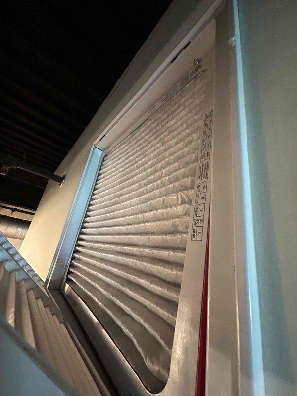 Completed annual AC tune-up on rooftop heat pump/air handler system accessed via stairwell. Inspected and photographed pleated air filter showing moderate dust accumulation in return air grille. Performed electrical diagnostics using multimeter, recording voltage reading of 3224 on system components and tested capacitor functionality. All routine maintenance procedures completed per manufacturer specifications.