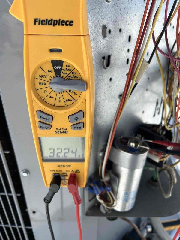 Completed annual AC tune-up on rooftop heat pump/air handler system accessed via stairwell. Inspected and photographed pleated air filter showing moderate dust accumulation in return air grille. Performed electrical diagnostics using multimeter, recording voltage reading of 3224 on system components and tested capacitor functionality. All routine maintenance procedures completed per manufacturer specifications.
